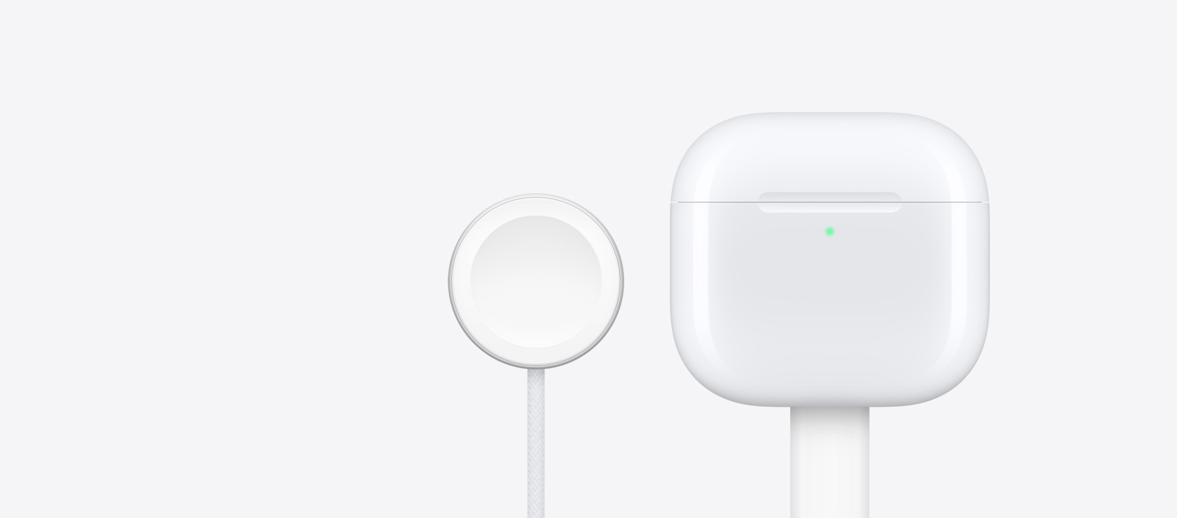 Etui ładujące AirPods 4 obok ładowarki Apple Watch.
