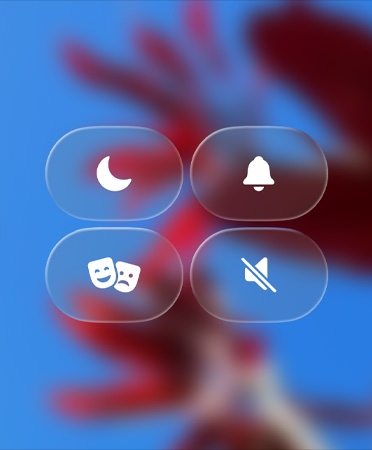 Translucent Control Center icons, including Do Not Disturb and Theater Mode, refract the blurred background