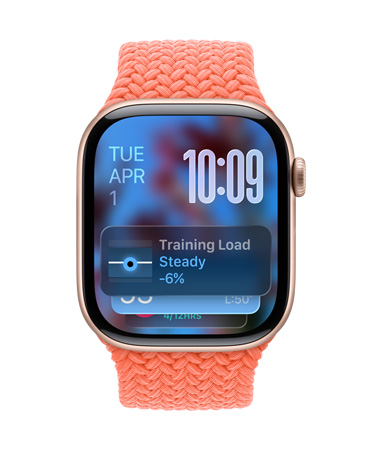 Apple Watch in Rose Gold with a braided band in Tangerine, face shows date at top left, time with stacked numerals at top right, Training Load widget at bottom, all in translucent Liquid Glass