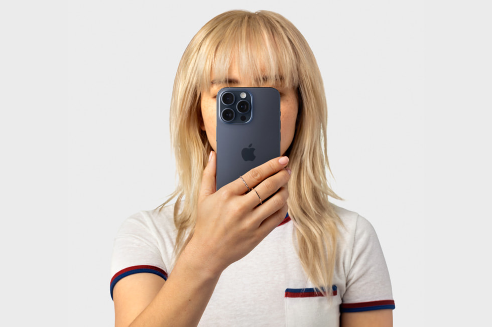 En person holder en iPhone 15 Pro opp til ansiktet.