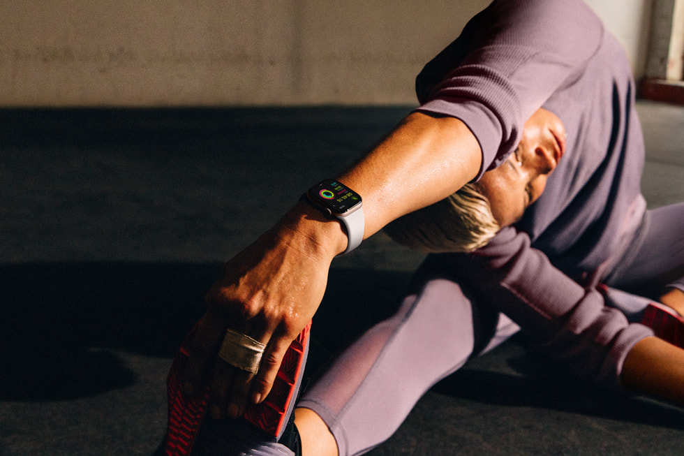 En person som har på seg Apple Watch Series 10, strekker ut i en yogalignende posisjon.