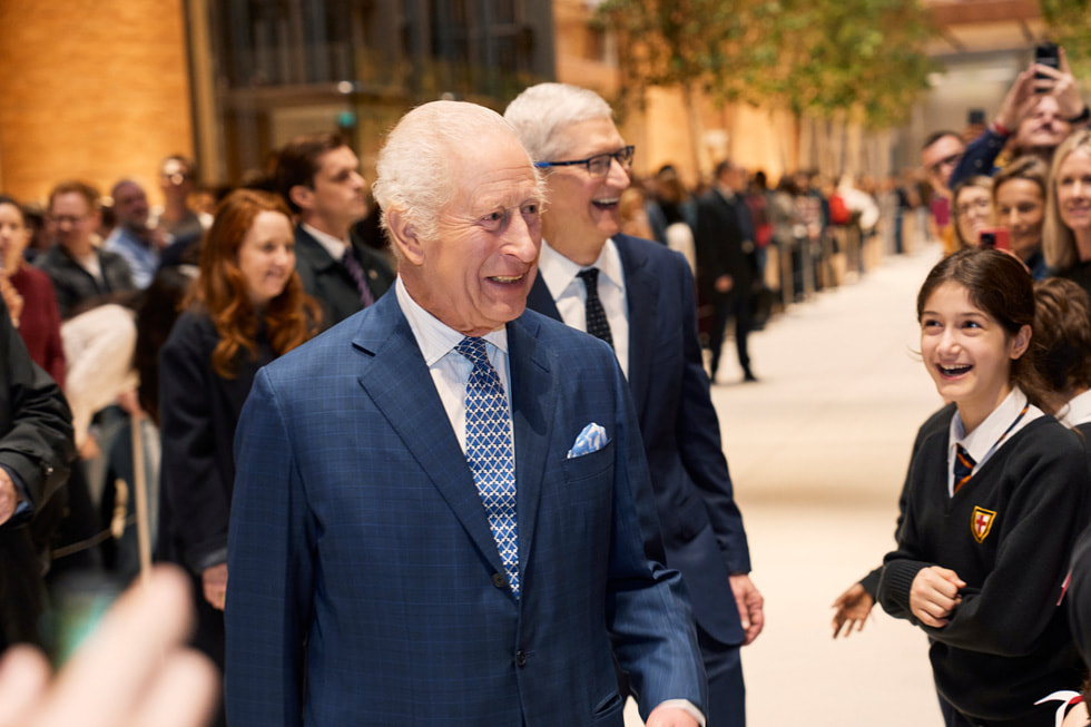 Le roi Charles et Tim Cook sourient en saluant les élèves de l’école primaire St. George.